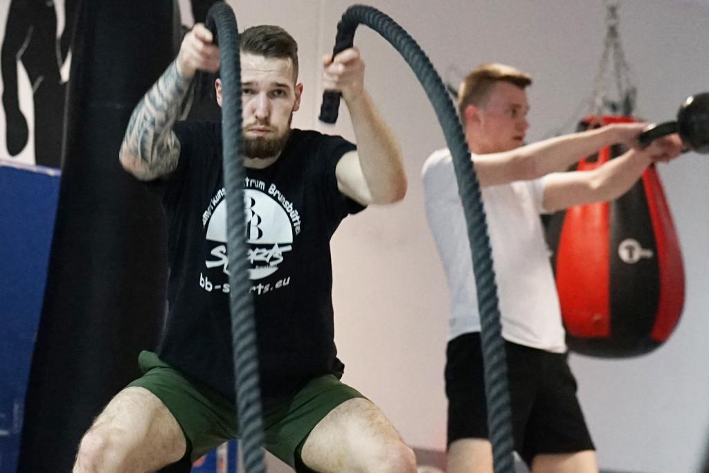 Mann mit Seilen bei Kampfsport Fitness Training